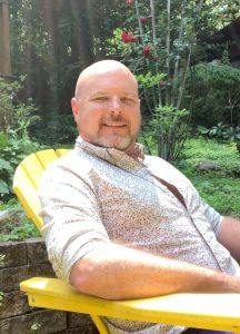 Kenneth Darby sitting in the sunshine in his garden.
